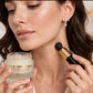 Adele Or solid perfume balm held by model with applicator
